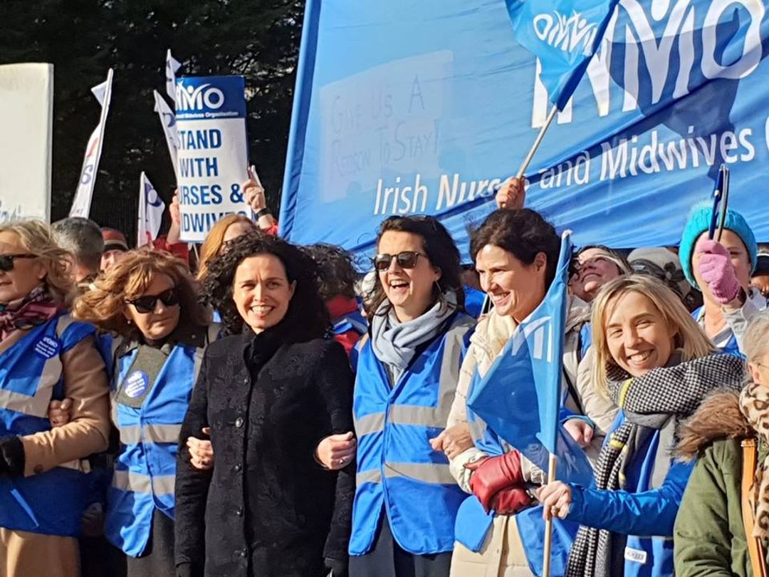 Tens of thousands march to support striking nurses and midwives